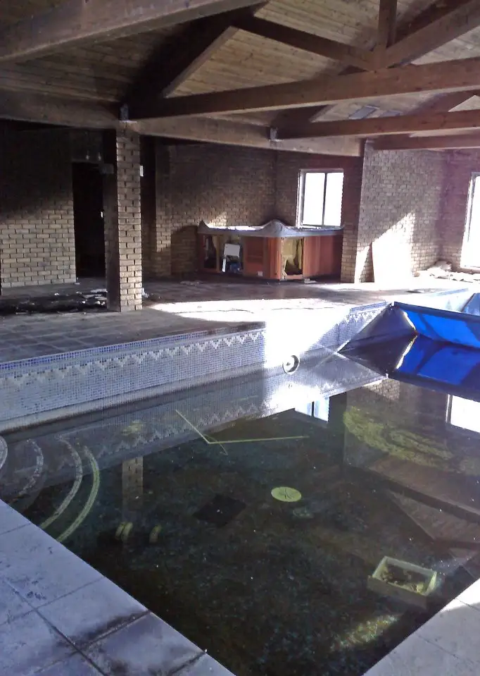 The swimming pool and Jacuzzzi at the abandoned and derelict mansion of &pound;9.4m lottery lout Michael Carroll. The house set in vast grounds is in a terrible state with every window smashed and every room trashed with litter left in great piles. Seemes Mikey really is a Pikey after all! Picture taken in March 2008.