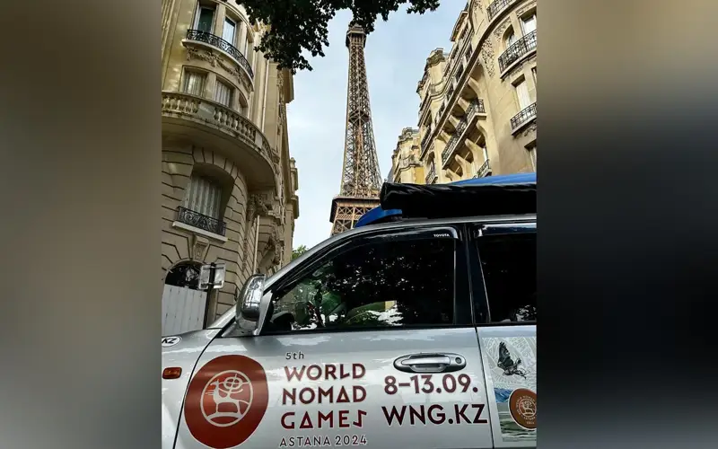 5th World Nomad Games-styled car cruises through the streets of Paris
