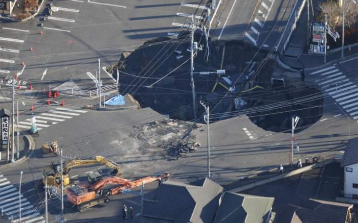 Photo taken from a Kyodo News helicopter shows the sinkhole at an intersection in Yashio, Saitama Prefecture, on Jan. 31, 2025. (Kyodo)