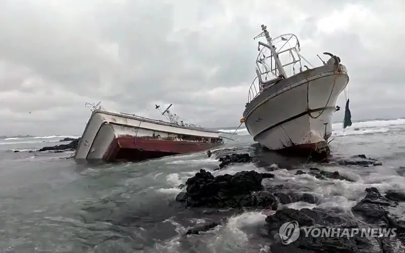 This photo, taken Feb. 1, 2025, shows two fishing boats that ran aground in waters off the southern resort island of Jeju. (Yonhap)