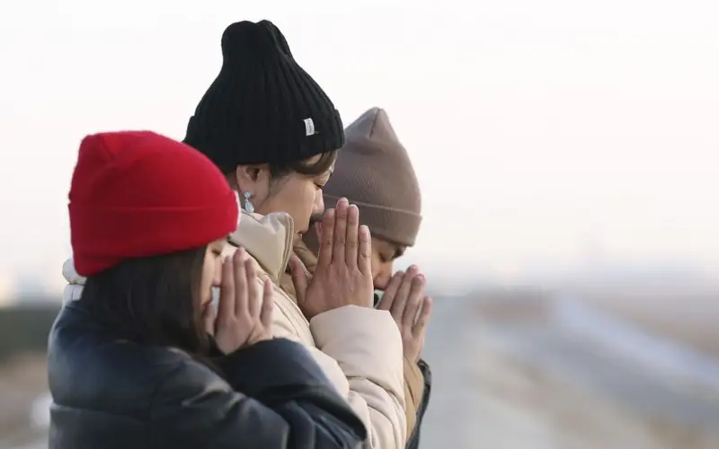 People pray facing out to sea in Sendai, Miyagi Prefecture, on March 11, 2025, the 14th anniversary of the earthquake, tsunami and nuclear disaster that devastated the country's northeast. 