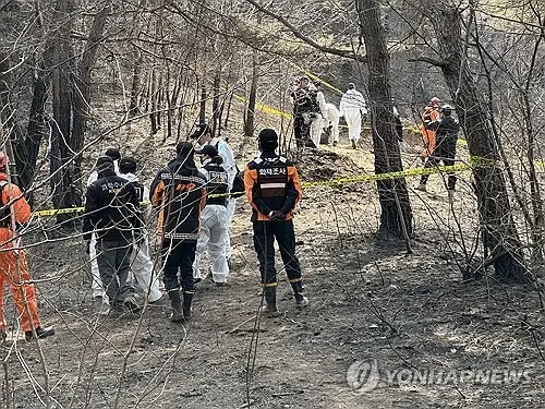 Police and other officials conduct a joint on-site investigation on March 31, 2025, at a grave site in the southeastern county of Uiseong, the original point of ignition for the nation's worst wildfires on record.