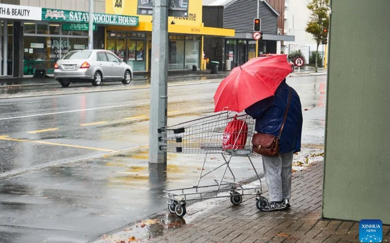 A pedestrian walks on a street in Christchurch, New Zealand, May 1, 2025. Severe weather has hit New Zealand on Thursday with a State of Emergency declared in part of the country.