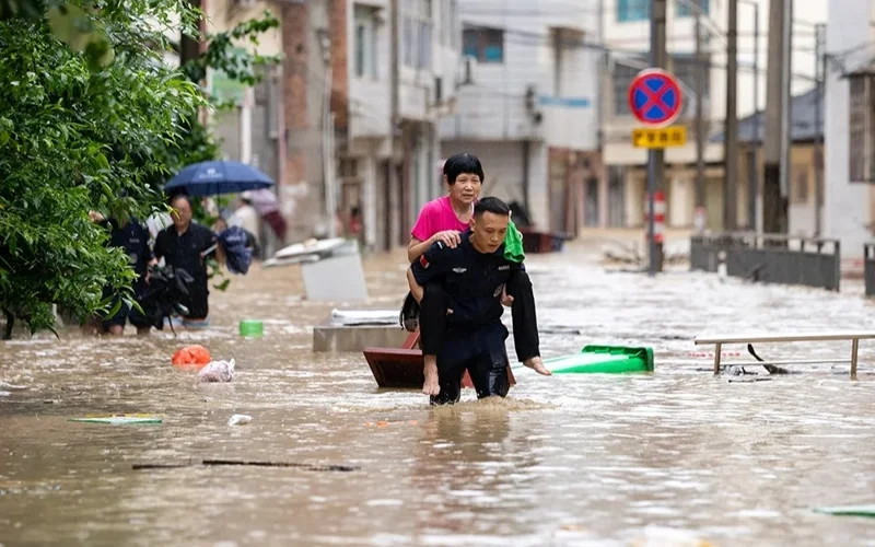 A rescuer helps evacuate a senior resident from a flood-affected area in Congjiang County, southwest China's Guizhou Province, June 24, 2025. (Photo by Wu Xingke/Xinhua)