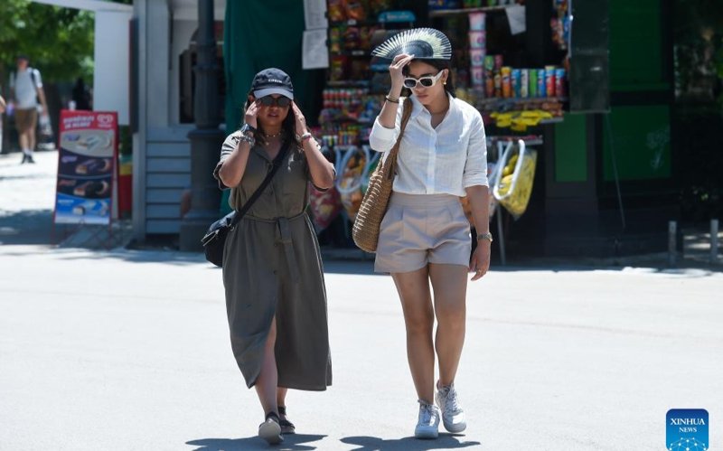 People walk on a street during a heat wave in Madrid, Spain, May 29, 2025. People walk on a street during a heat wave in Madrid, Spain, May 29, 2025.