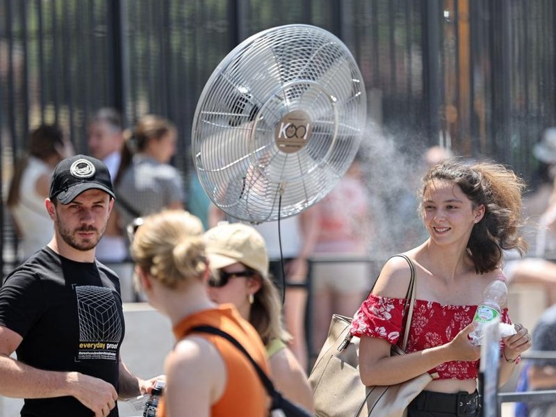 People walk on a street during a heat wave in Madrid, Spain, May 29, 2025. 