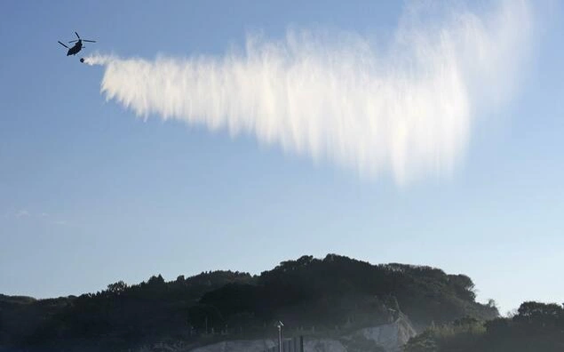 Massive fire in southwest Japan mostly contained, uninhabited still burning