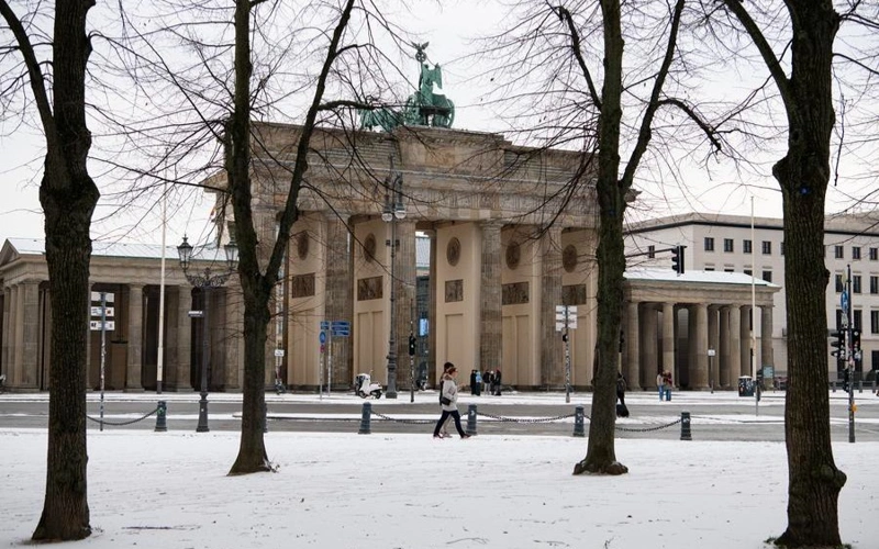 People walk past the Brandenburg Gate in Berlin, Germany, Nov. 24, 2025. Berlin saw its first snowfall of the winter season on Monday.