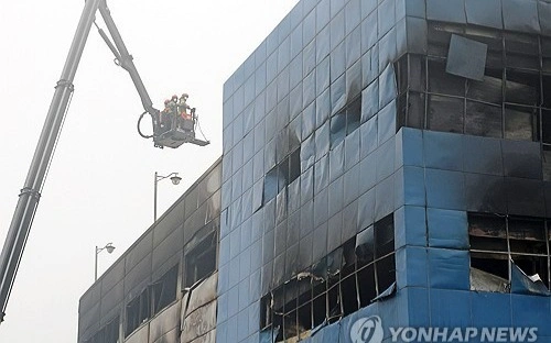 Firefighters search for missing people at a car parts plant after a large fire engulfed the building in the central city of Daejeon on March 21, 2026.
