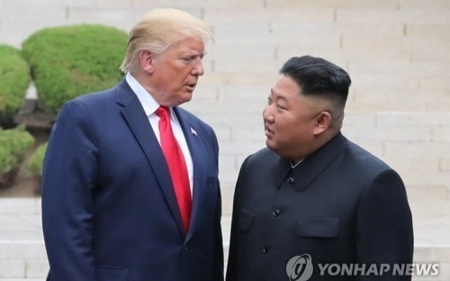 This file photo, taken June 30, 2019, shows U.S. President Donald Trump (L) and North Korean leader Kim Jong-un meeting at the inter-Korean border village of Panmunjom