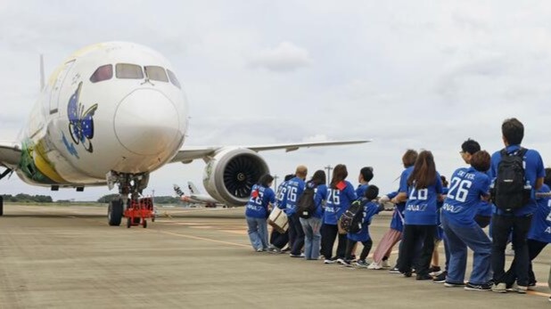 About 360 people pull Pokémon-themed aircraft at Japanese airport
