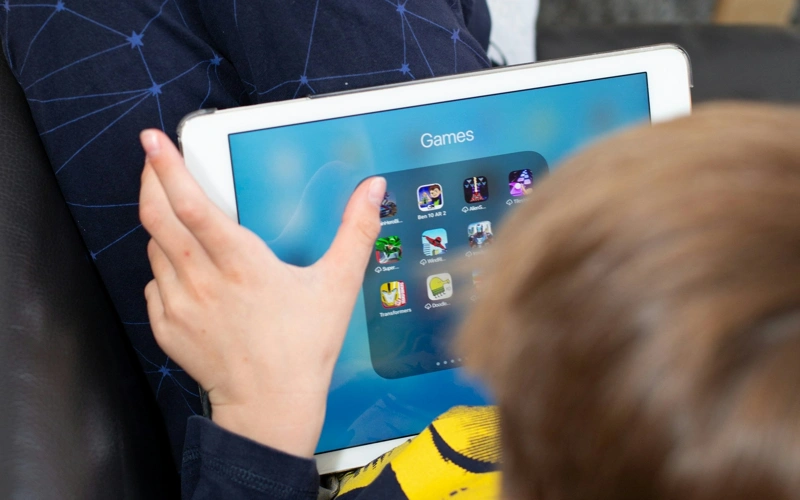 A young boy holding a tablet